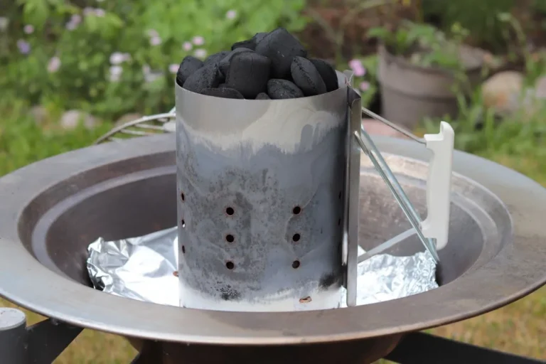 Lumpwood charcoal being prepared in a chimney starter
