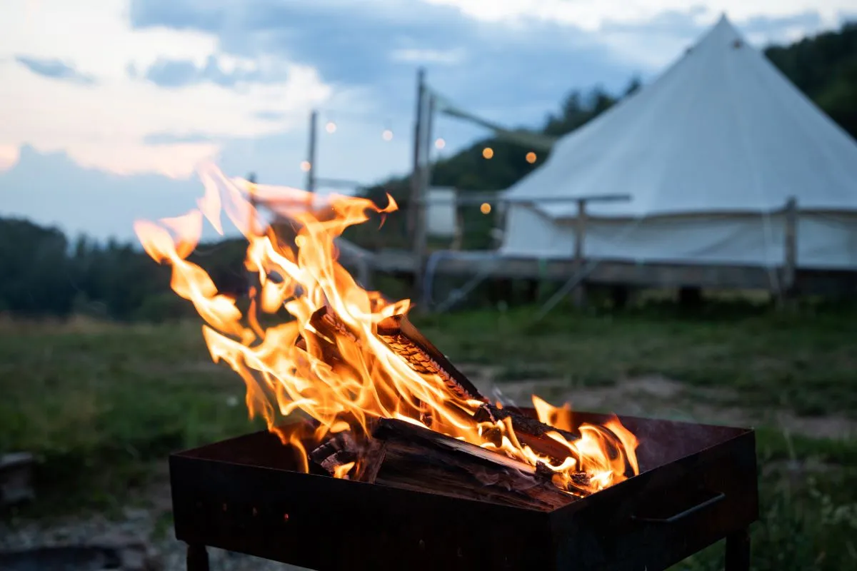 campfire with tents in the background